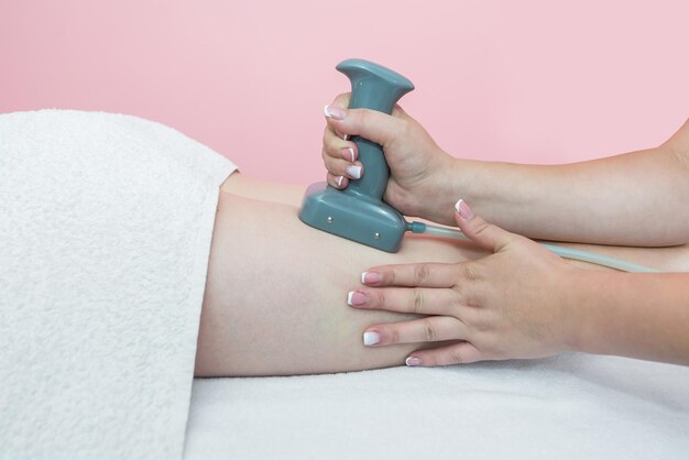 Closeup of a woman undergoing an anticellulite massage procedure in a beauty salon