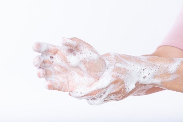 Closeup woman washing hands with soap.