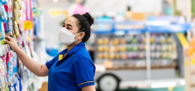 Closeup Woman wearing mask who chose goods for her special day In a supermarket on a casual day Concept for shopping lifestyle selective focus copy space on right for design blurred background