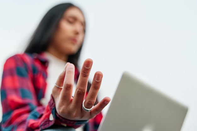 Closeup of a woman with laptop computer and more meditating hands Selective focus