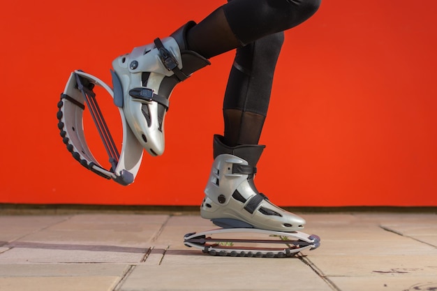 Closeup of a womans legs wearing kangoo jumps boots during physical activity