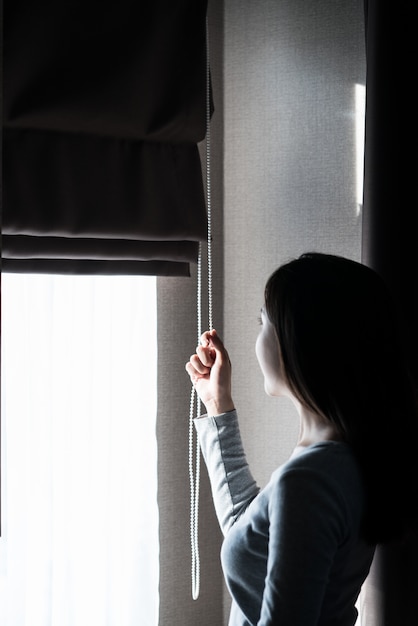 Closeup of women hand opening curtain