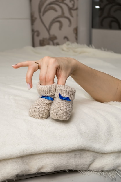 Closeup of womens hands holding baby booties