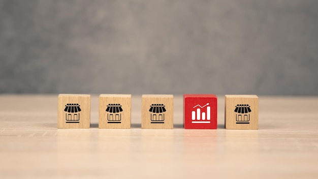 Closeup wooden block stack with graph and franchise business store icon