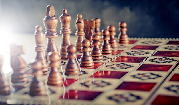 Closeup wooden figures on chess game board