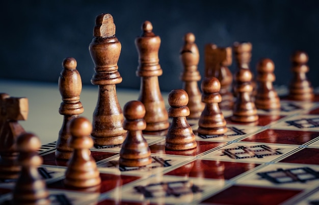 Closeup wooden figures on chess game board