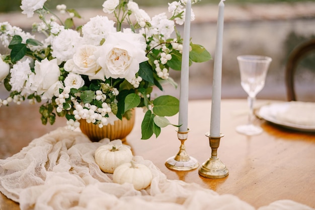 Closeup of a wooden table decorated for a wedding dinner