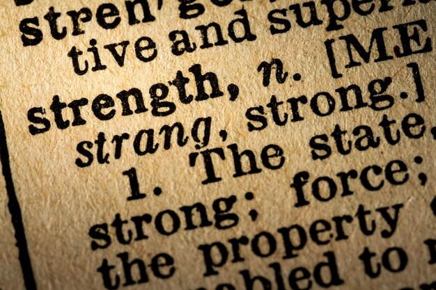 Photo closeup of the word strength and its definition