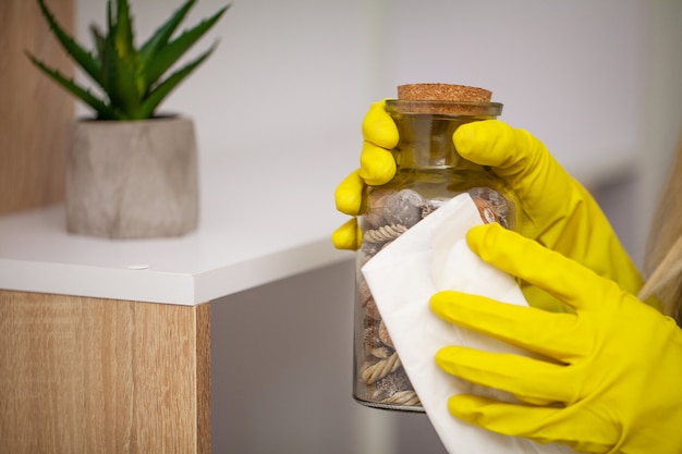 Closeup of worker hand wiping dust in office