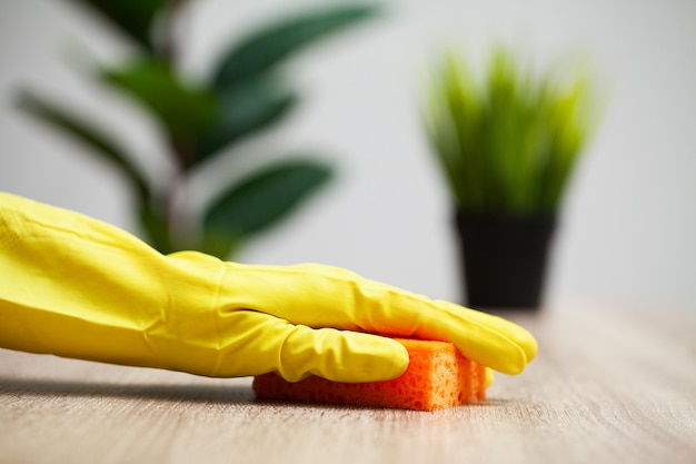 Closeup of worker hand wiping dust in office