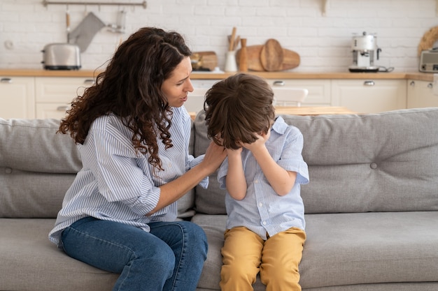 Closeup of worried mother calms weeping kid