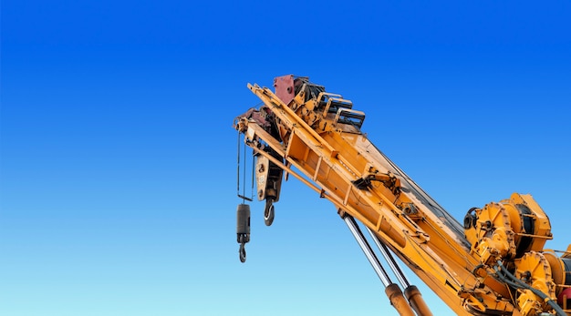 Closeup yellow truck crane in construction site 