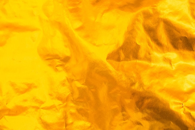 Closeup of yellow wrinkled paper texture background