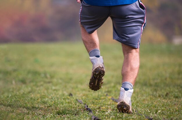 closeup of young american football player exercises on ladder drills at field