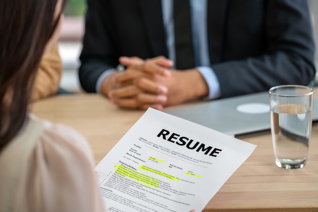 Photo closeup young asian woman graduate holding the resume document and preparing