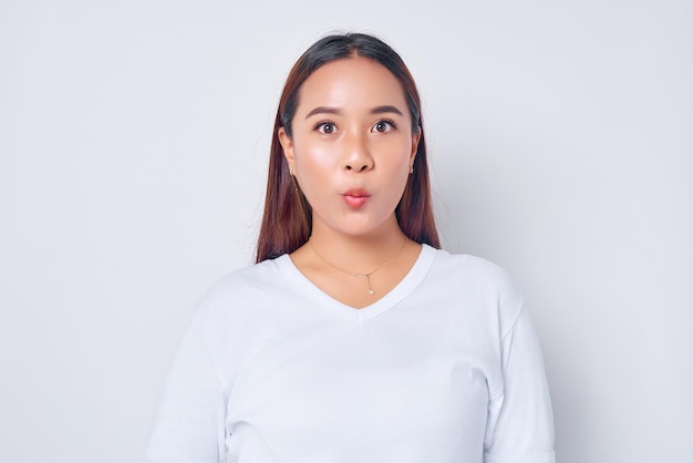 Closeup young blonde woman Asian wearing casual white tshirt looking at camera with amazed expression isolated on white background people lifestyle concept