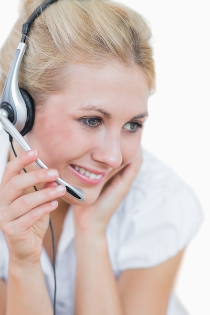 Closeup of young female executive wearing headset