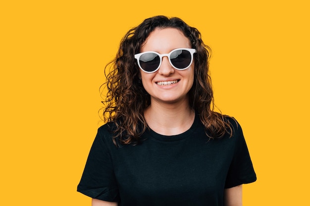 CloseUp of Young Happy Woman Wearing Sunglasses Studio Shot