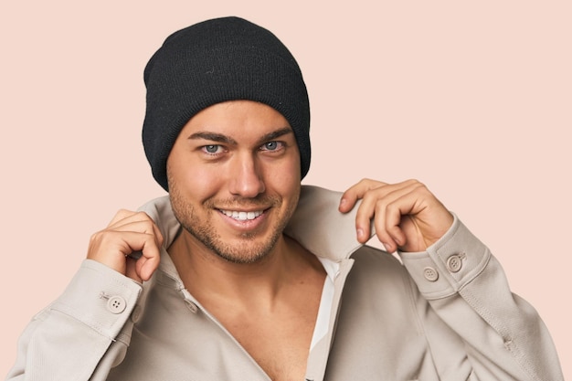 Closeup of a young man in a wool hat showcasing winter fashion