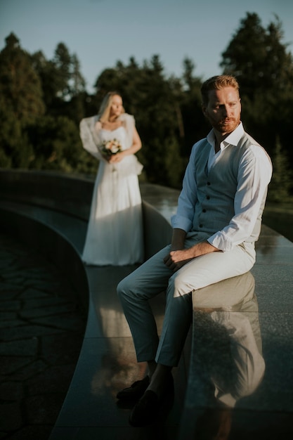 Крупным планом молодой человек молодоженов сидит перед своей молодой невестой