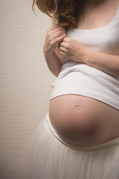 Closeup of young pregnant woman's belly Expecting a baby Motherhood and childhood