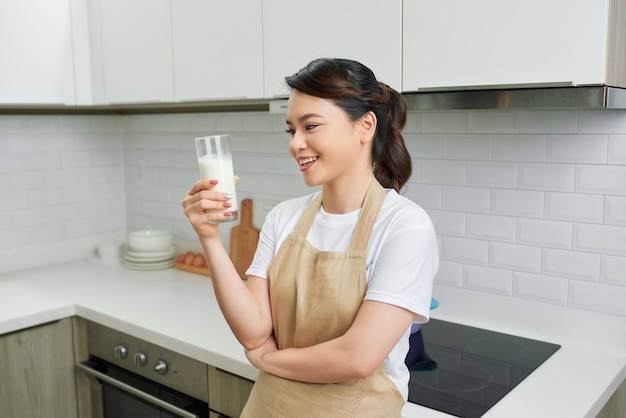 Closeup on young woman drinking milk