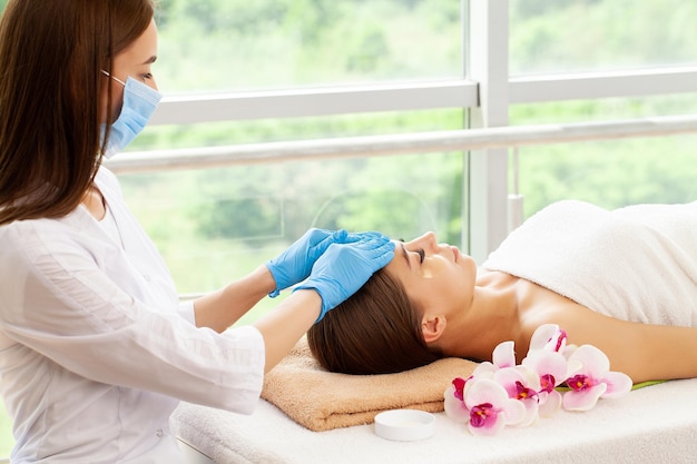 Closeup of young woman getting spa massage treatment at beauty spa salon