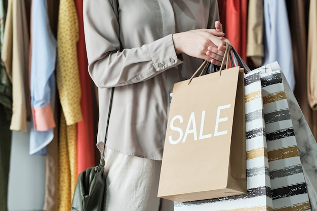 closeup of young woman holding shopping bags while making purchases in the shopping mall
