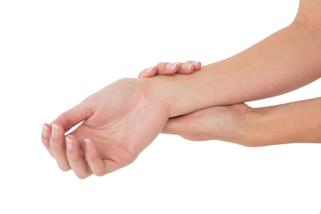 Closeup of a young woman touching her wrist