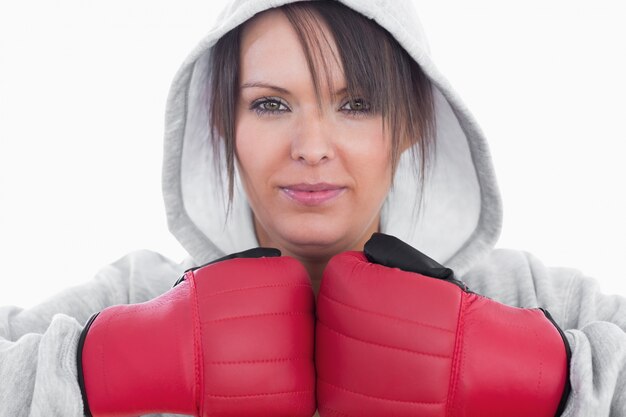 Closeup of young woman wearing boxing gloves