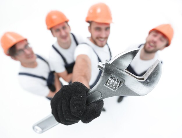 Closeupa team of builders showing a pipe wrench