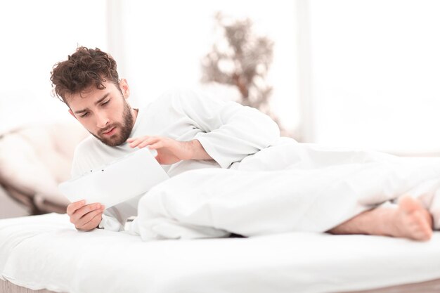 Closeupawakened man typing with a digital tablet