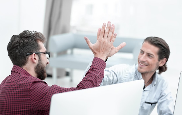 Closeupcolleagues giving each other high five