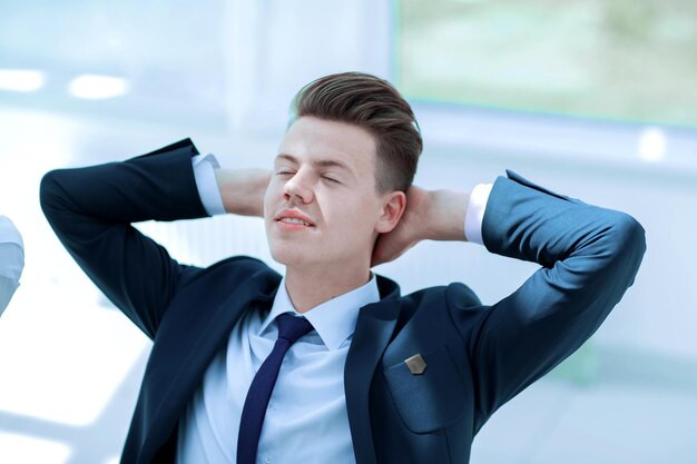 Closeupmeditating businessman sitting behind a Desk Relaxation techniques at workplace