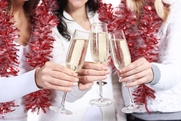 Closeupthree young women with glasses of champagne