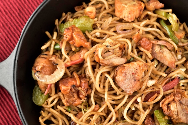 Closuep of chicken chow mein in plate