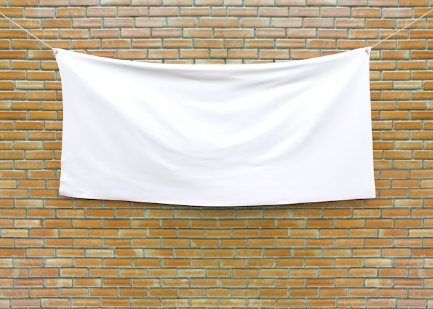 Cloth banner hanging on brick wall