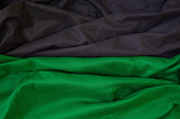 Cloth waves close up the background Stacked Creased fabric 3 color black green white