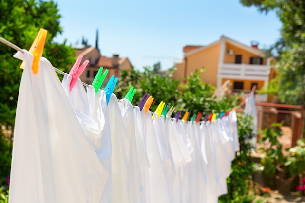 Cloth with colorful pins is drying at the yard