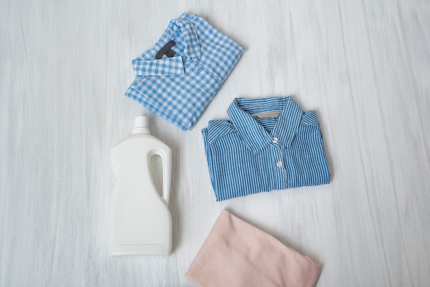 Clothes and bottle with detergent. Top view