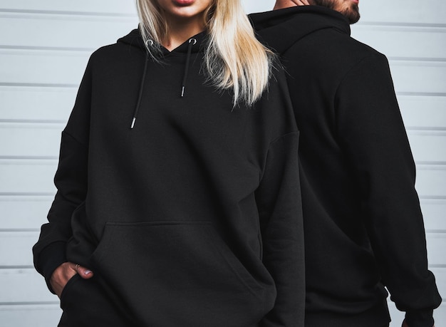 clothes branding mockup design template for casual sportswear woman stands in hoodie with no logo