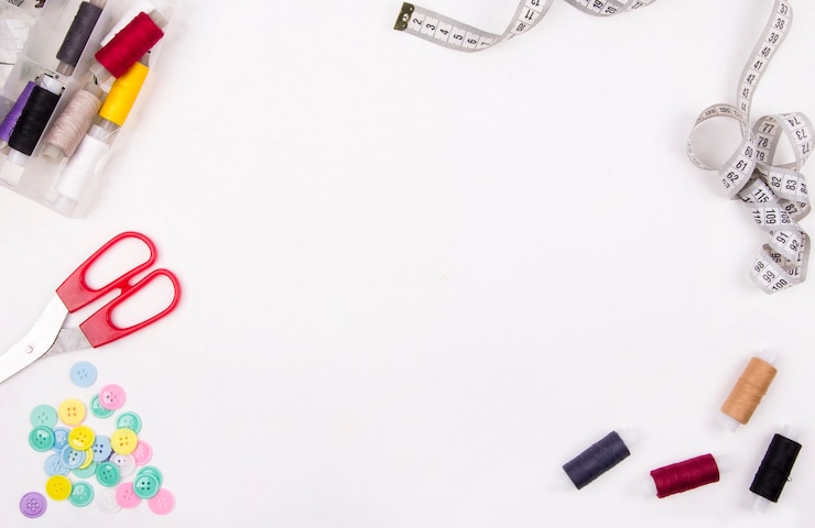 Photo clothes designer work desk pattern scissors thread textile on white background topdown
