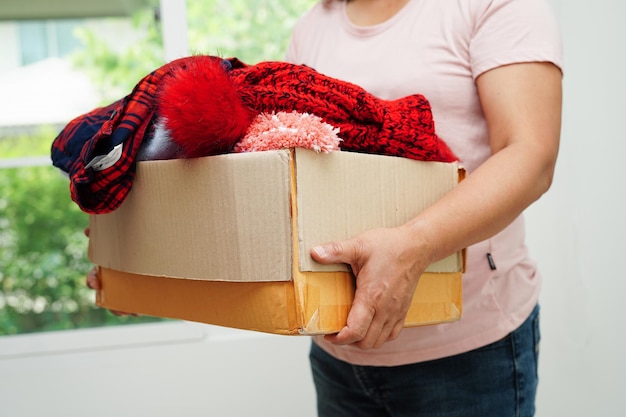 Clothes donations in cardboard box for volunteer