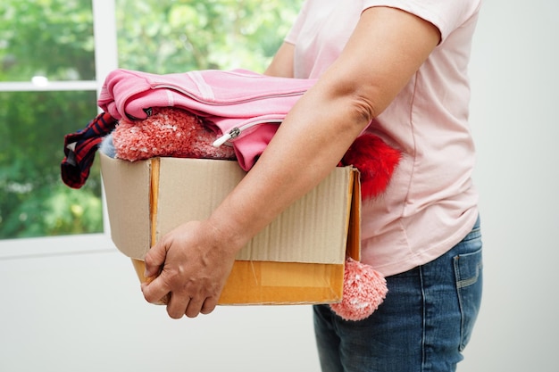 Clothes donations in cardboard box for volunteer