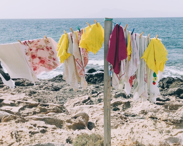clothes drying on beach against sea