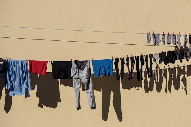 Clothes drying on clothesline against wall