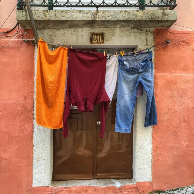 Clothes drying on clothesline by door of house