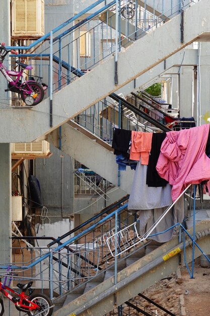 Clothes drying on railing by building