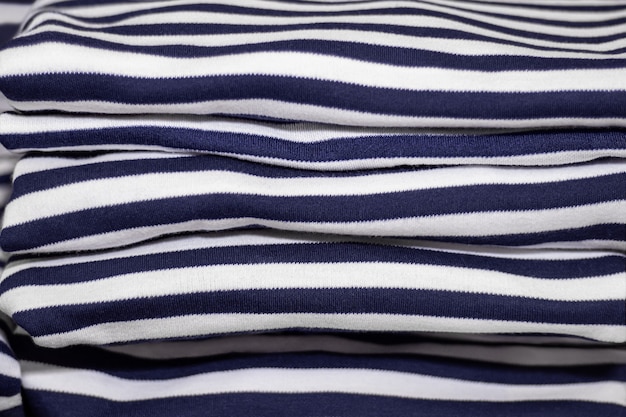 Clothes folded in a pile - ironed striped T-shirts.