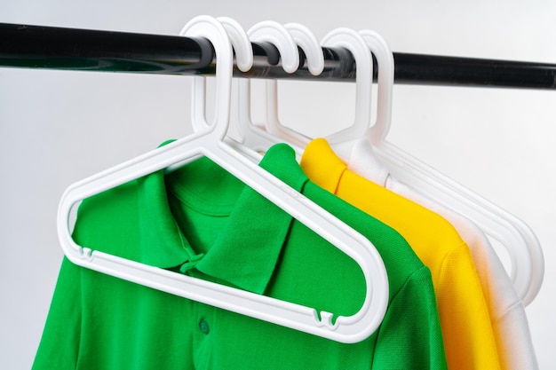 Clothes hang on clothing rack over white background